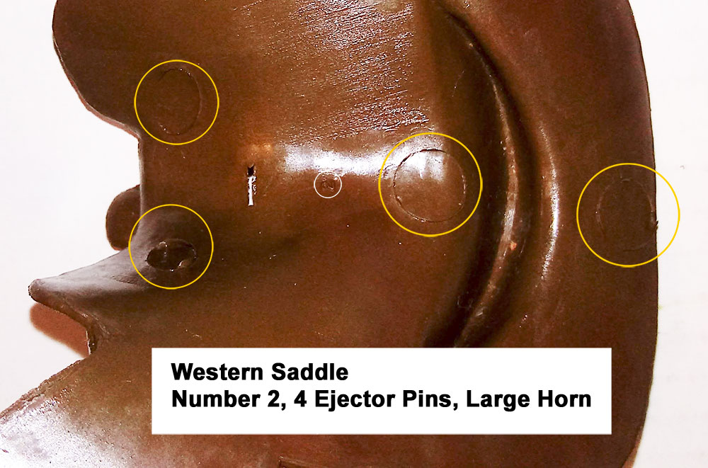 Western Saddle with large saddle horn, Number 2 (small font), Cavity had 2 large ejector pins under the seat and rear of the saddle, and 2 smaller ones on the forward part of the saddle.